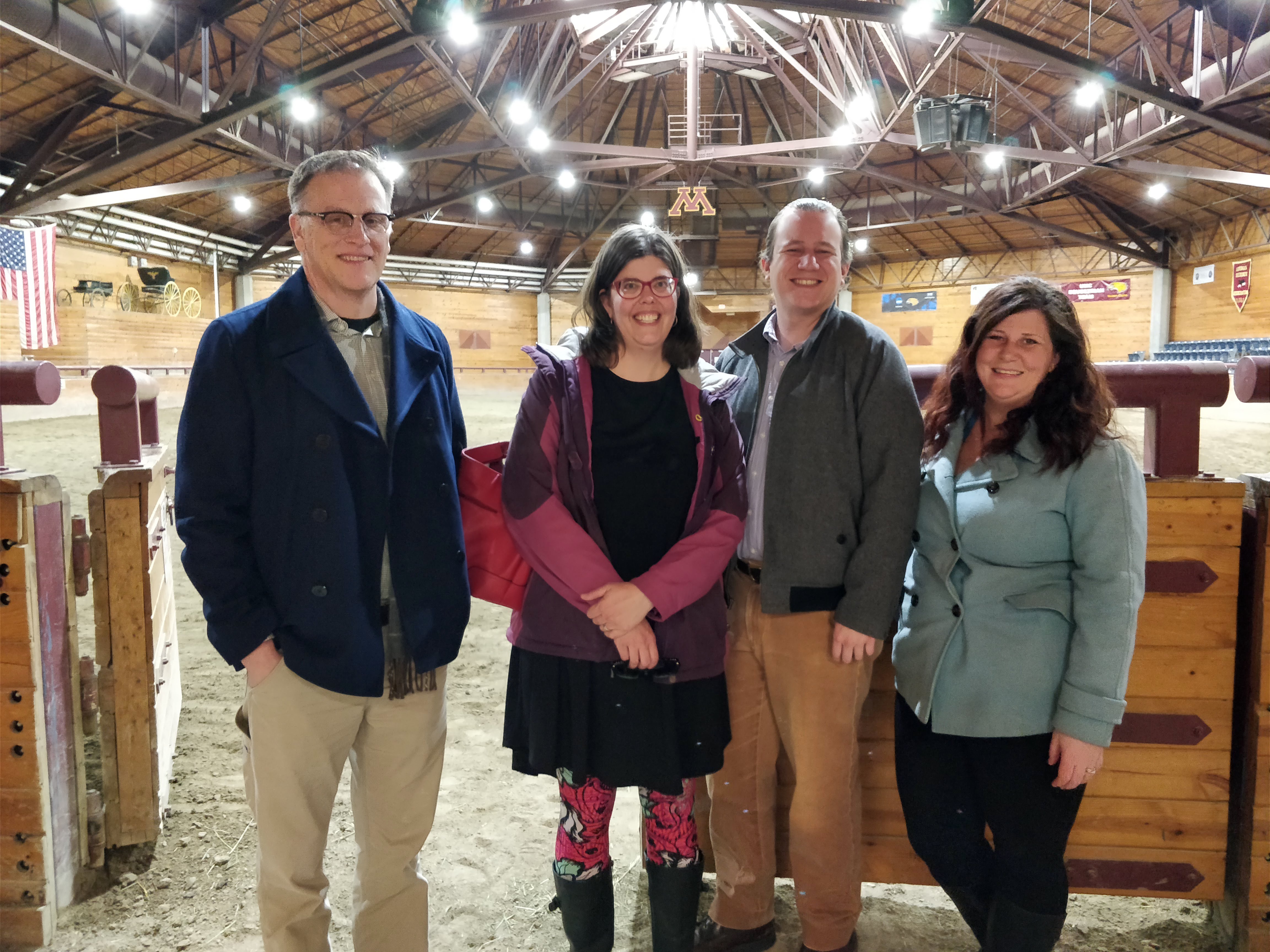 Ray Muno, Ann Hagen, Ian Ringgenberg, and Becky Nelson pose in the riding arena at the Crookston campus