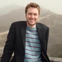Professor Ben Narvaez poses in front of mountains